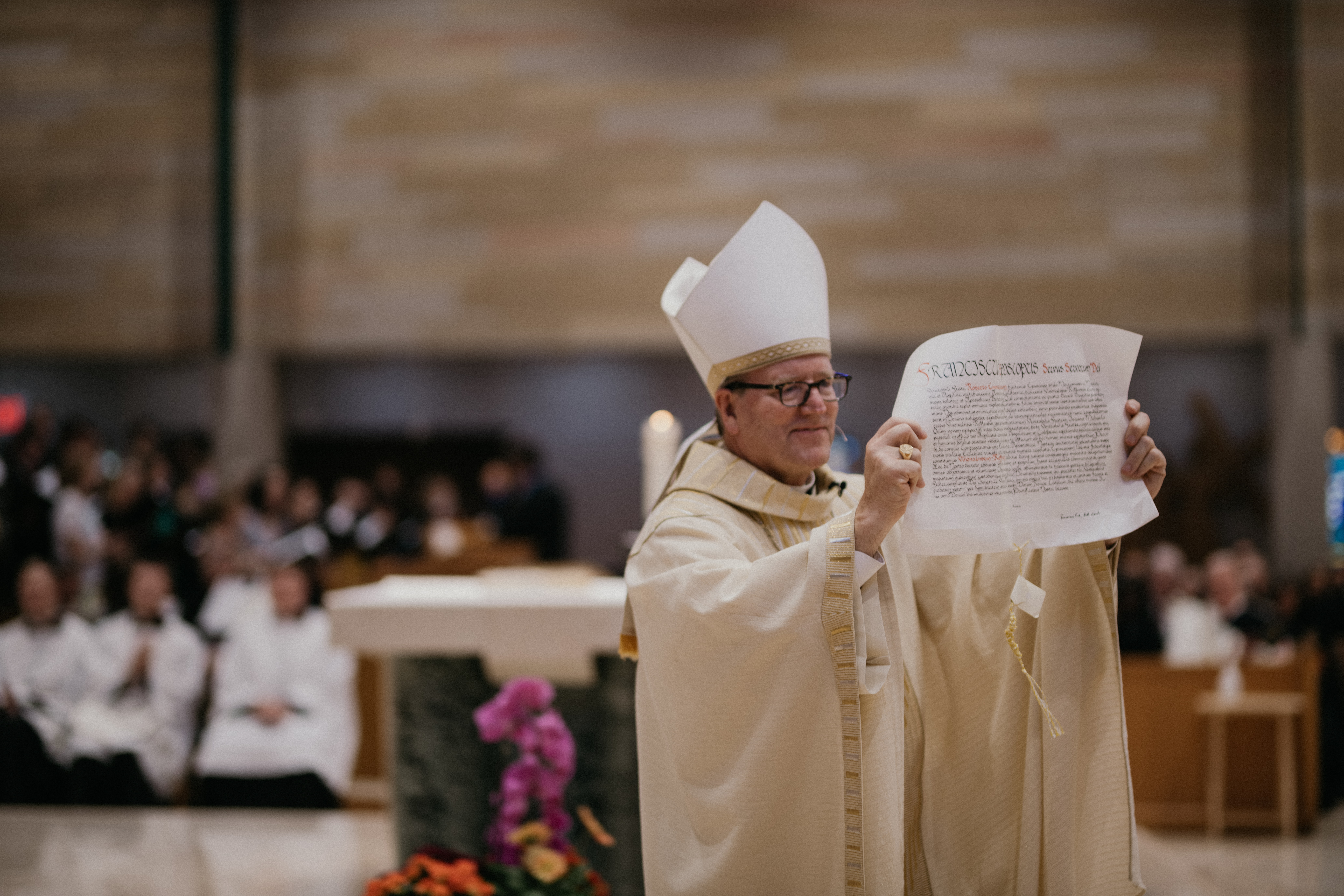 Bishop Barron, with the Papal Bull announcing him as the ninth bishop of the Diocese of Winona - Rochester
